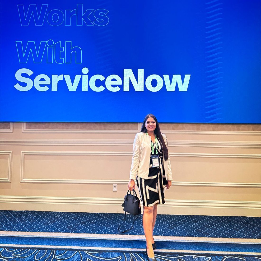Surbhi Rawat in front of the Works with ServiceNow stage at Knowledge